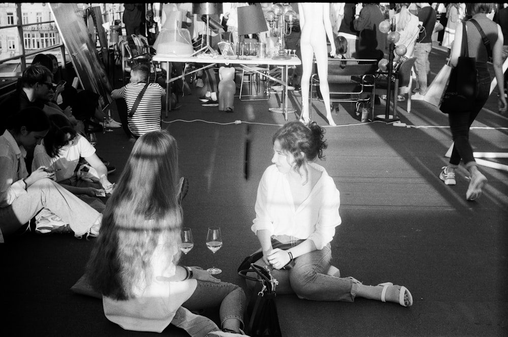 grayscale photo of woman and girl sitting on floor