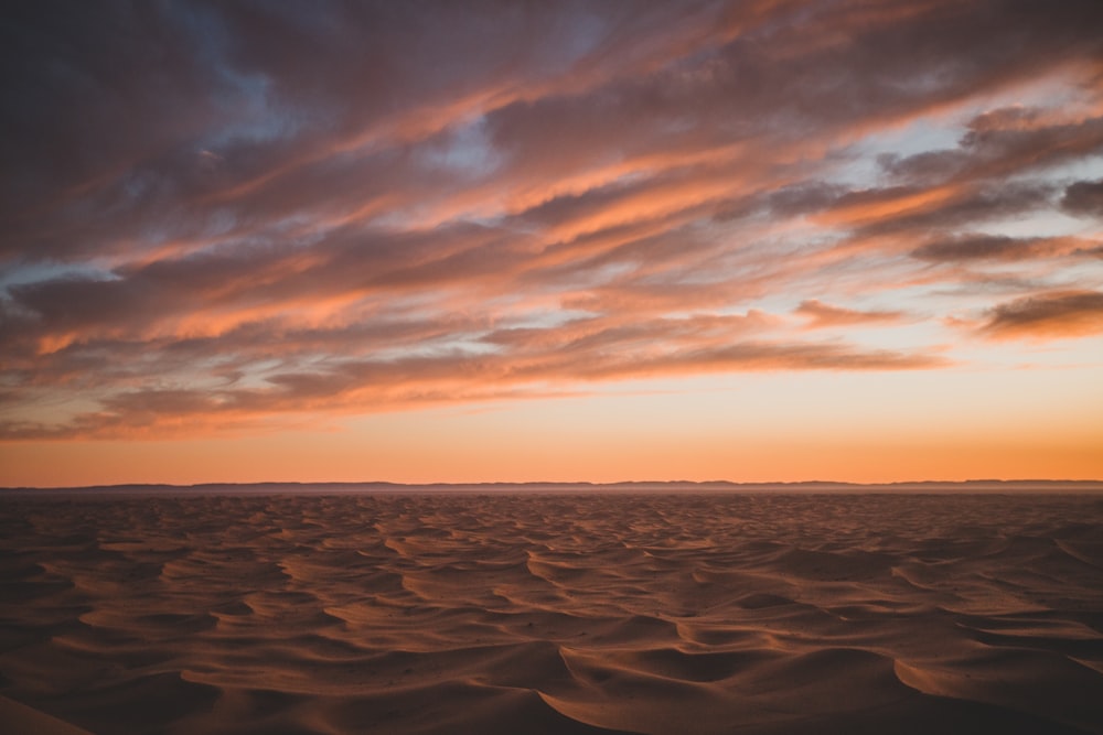 white sand under cloudy sky during daytime