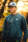 man in blue crew neck long sleeve shirt wearing black framed eyeglasses