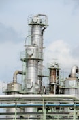 white and brown factory under blue sky during daytime