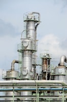 white and brown factory under blue sky during daytime