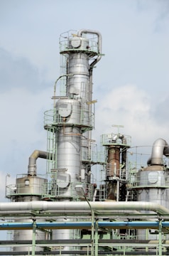 white and brown factory under blue sky during daytime