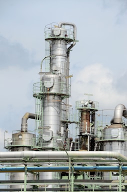 white and brown factory under blue sky during daytime