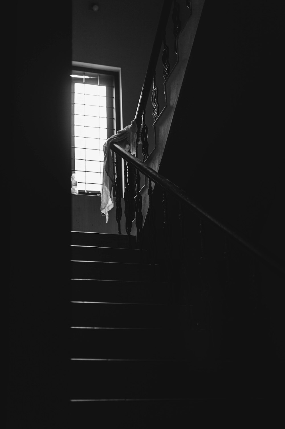 grayscale photo of staircase in a dark room