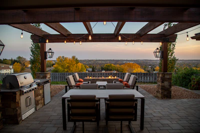 Covered patio with outdoor grill and dining area