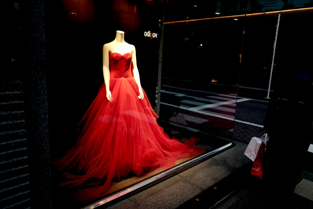 woman in red dress standing on black floor
