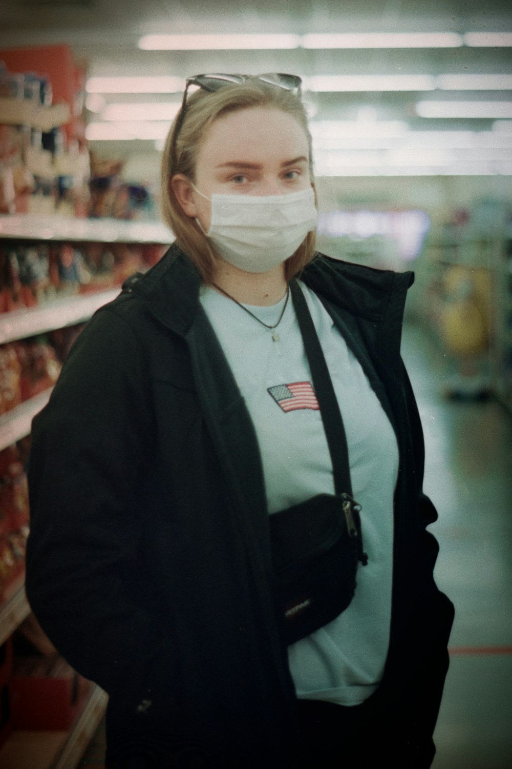 woman in black jacket wearing white face mask