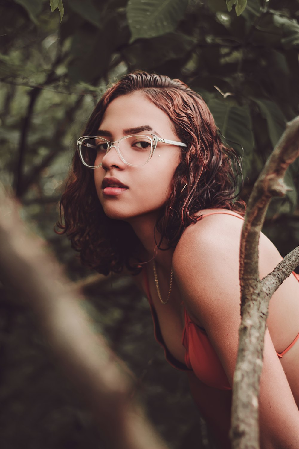 woman in red tank top wearing black framed eyeglasses