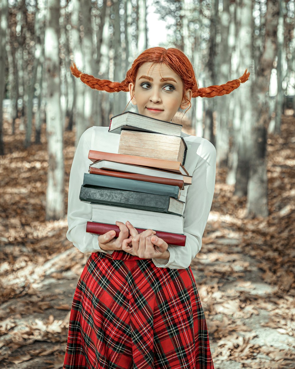 woman in red and white plaid dress shirt holding books