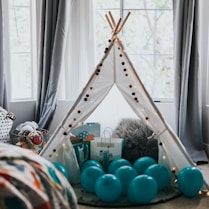 blue and green balloons on white metal rack