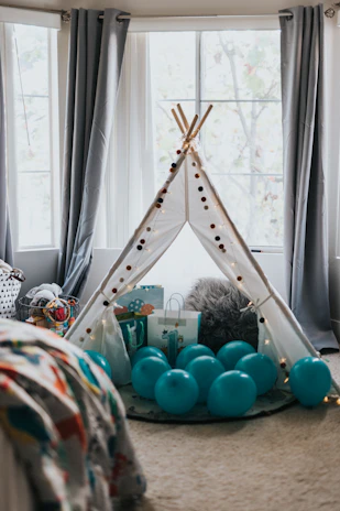 A cozy home decor scene with subtle tent decorations and floral door hangings.
