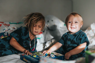 Kids engaged in a fun puzzle activity from an activity book, smiling and learning together.