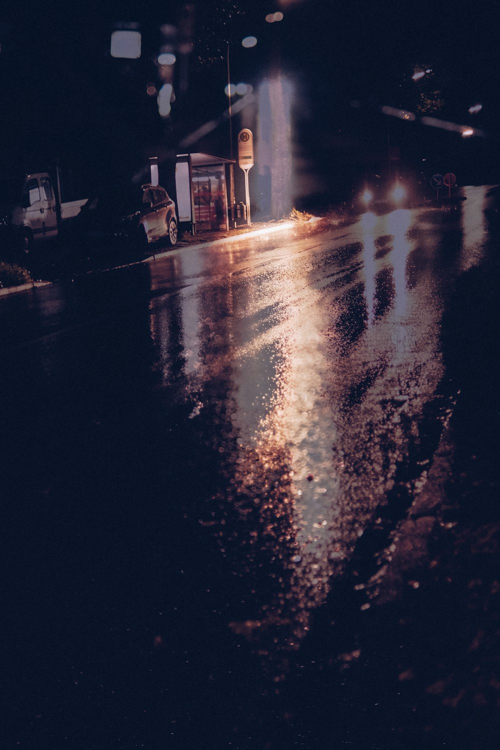 a wet street at night with a traffic light