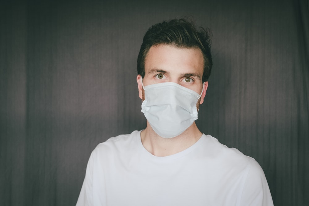 man in white crew neck shirt wearing white face mask