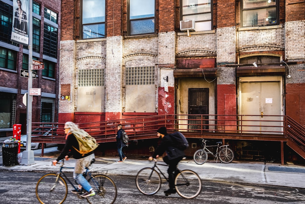 man in black jacket and black pants riding bicycle