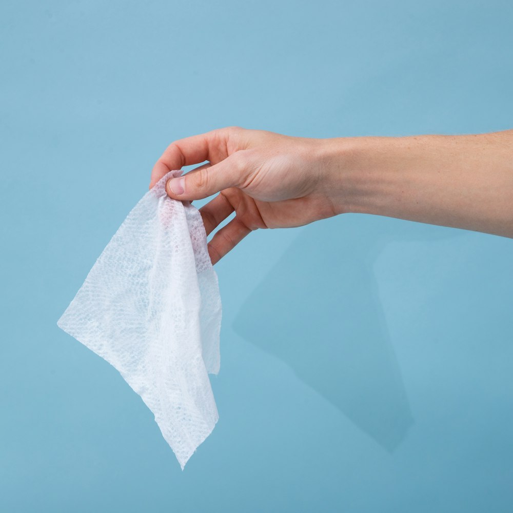 person holding white tissue paper