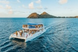 people riding on white boat on sea during daytime