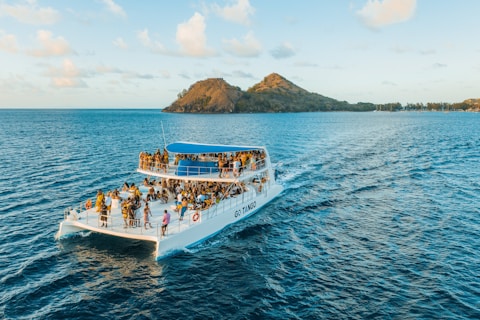 people riding on white boat on sea during daytime