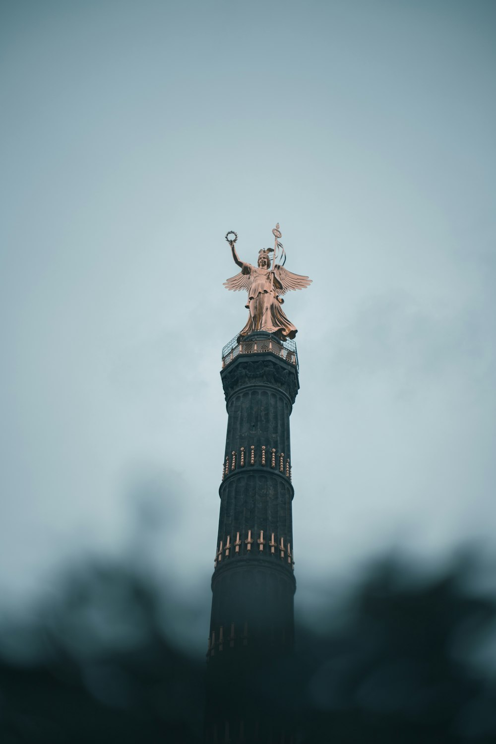 man in red jacket and black pants standing on tower