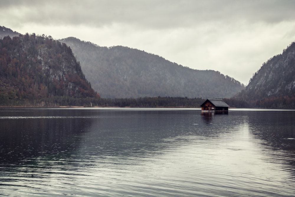 brown wooden house on lake during daytime