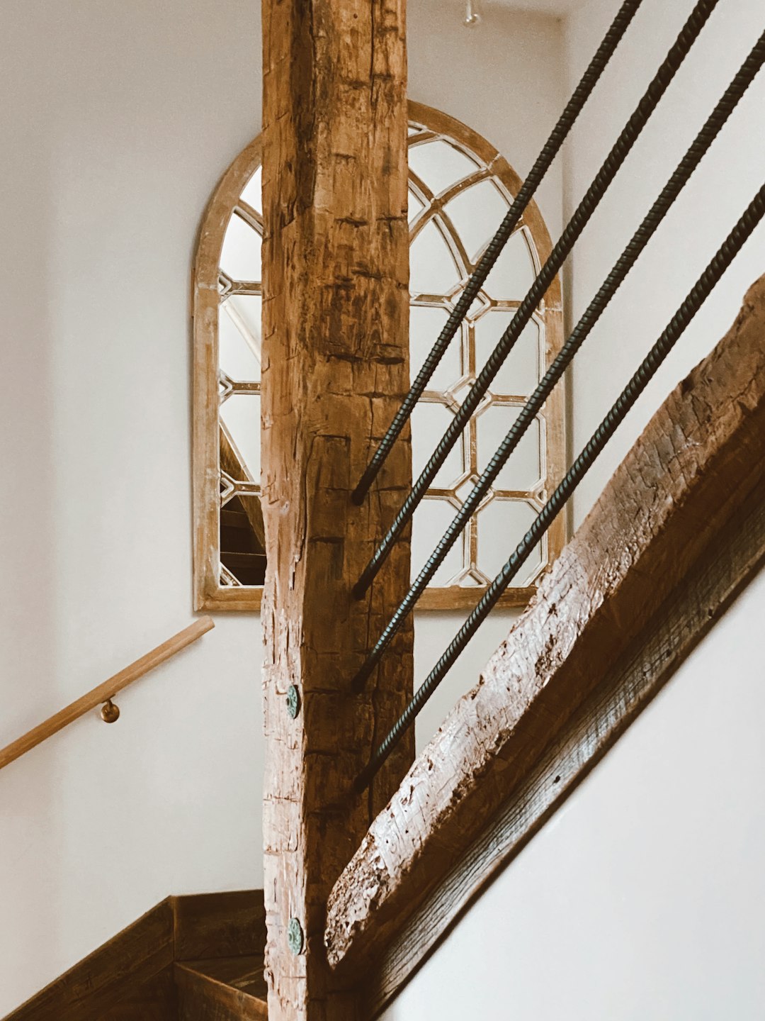 brown wooden spiral staircase on white painted wall