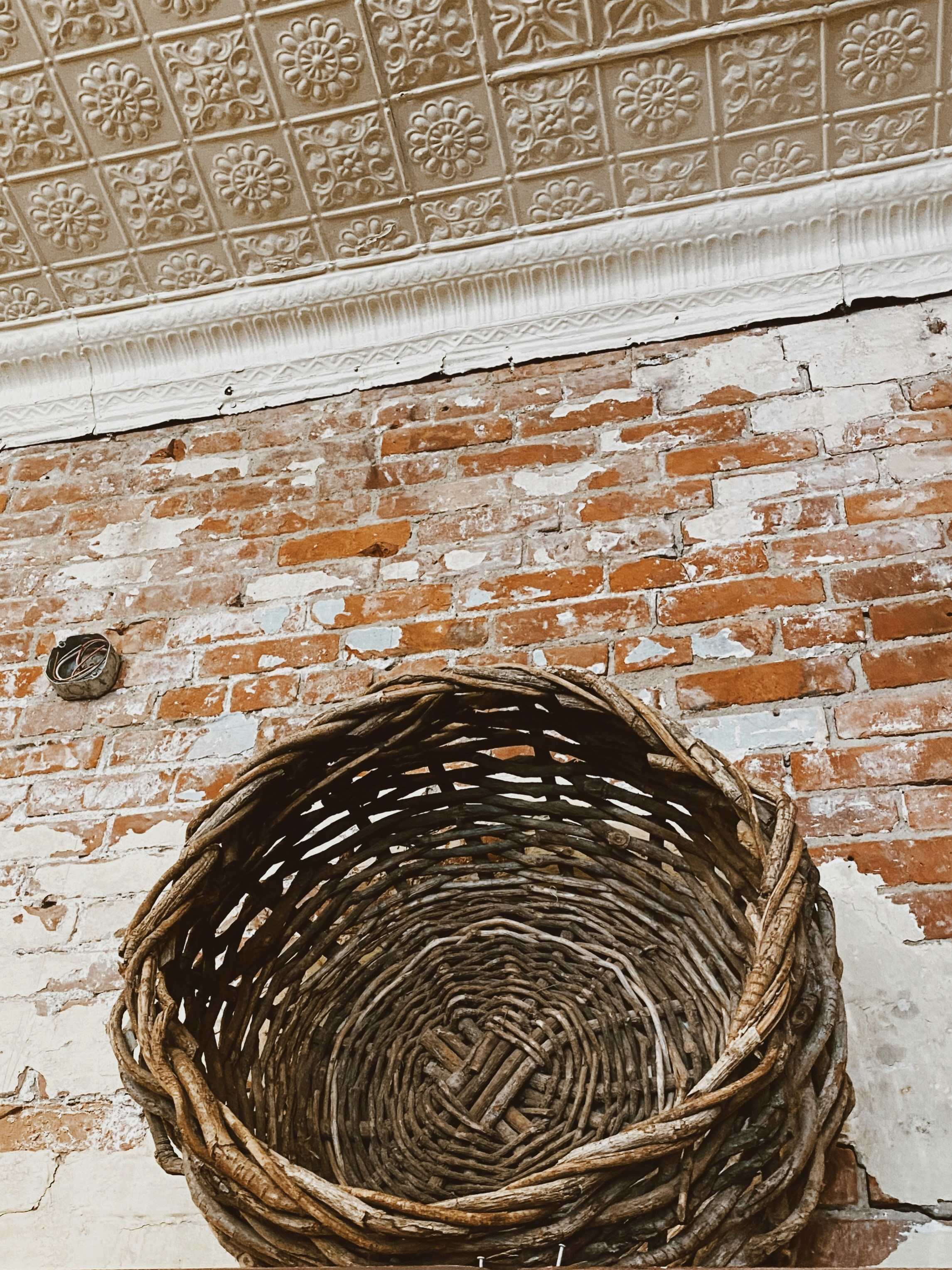 brown brick wall with brown wooden round hole