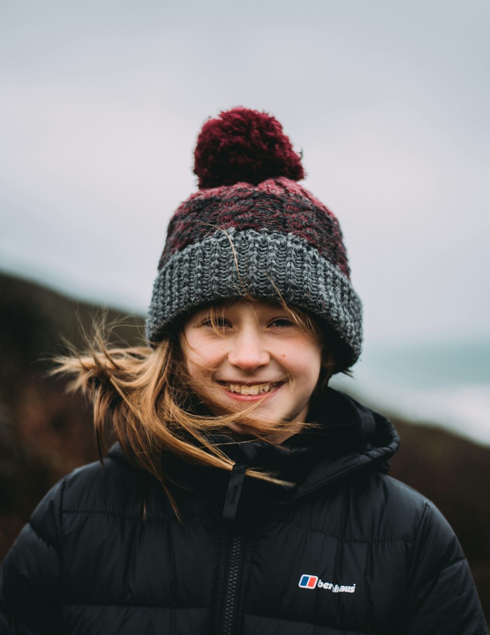 woman in black and white knit cap and black jacket