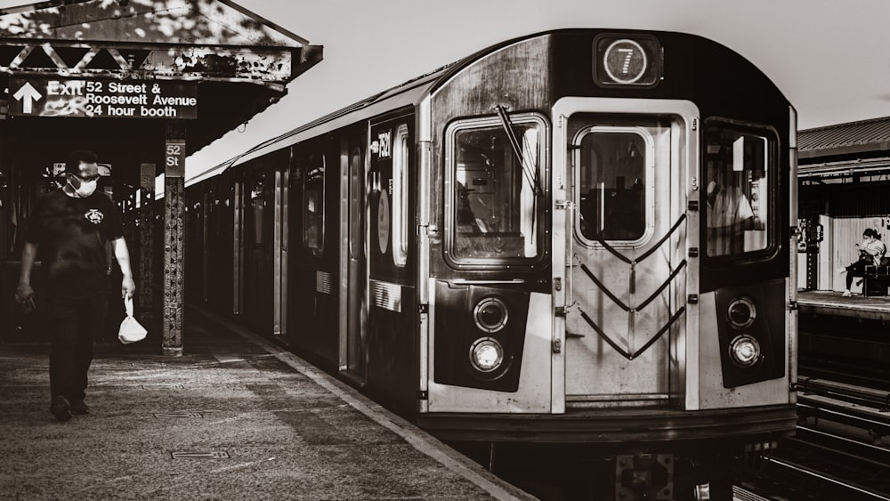 grayscale photo of train on rail road