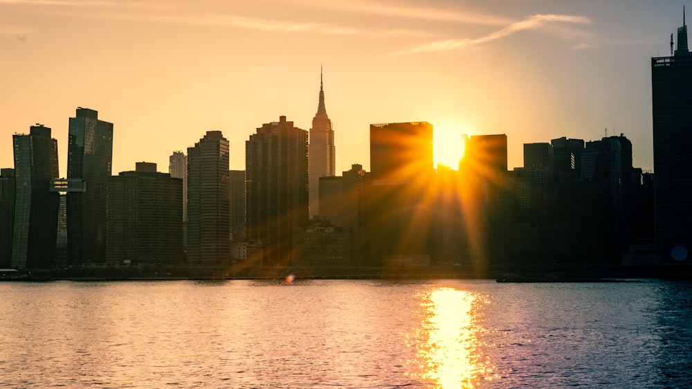 city skyline during sunset with body of water