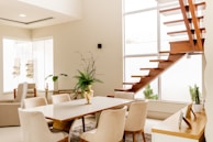 Bright dining room digitally staged with minimalist style and natural textures.