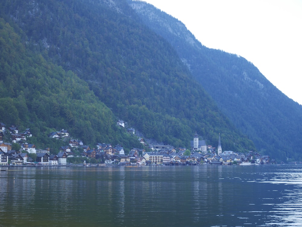 green mountain beside body of water during daytime