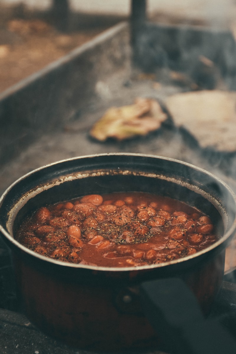 Rustic pot of beans stewing slowly in tomato sauce