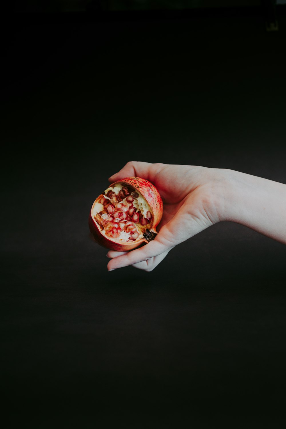 person holding red and brown round ornament