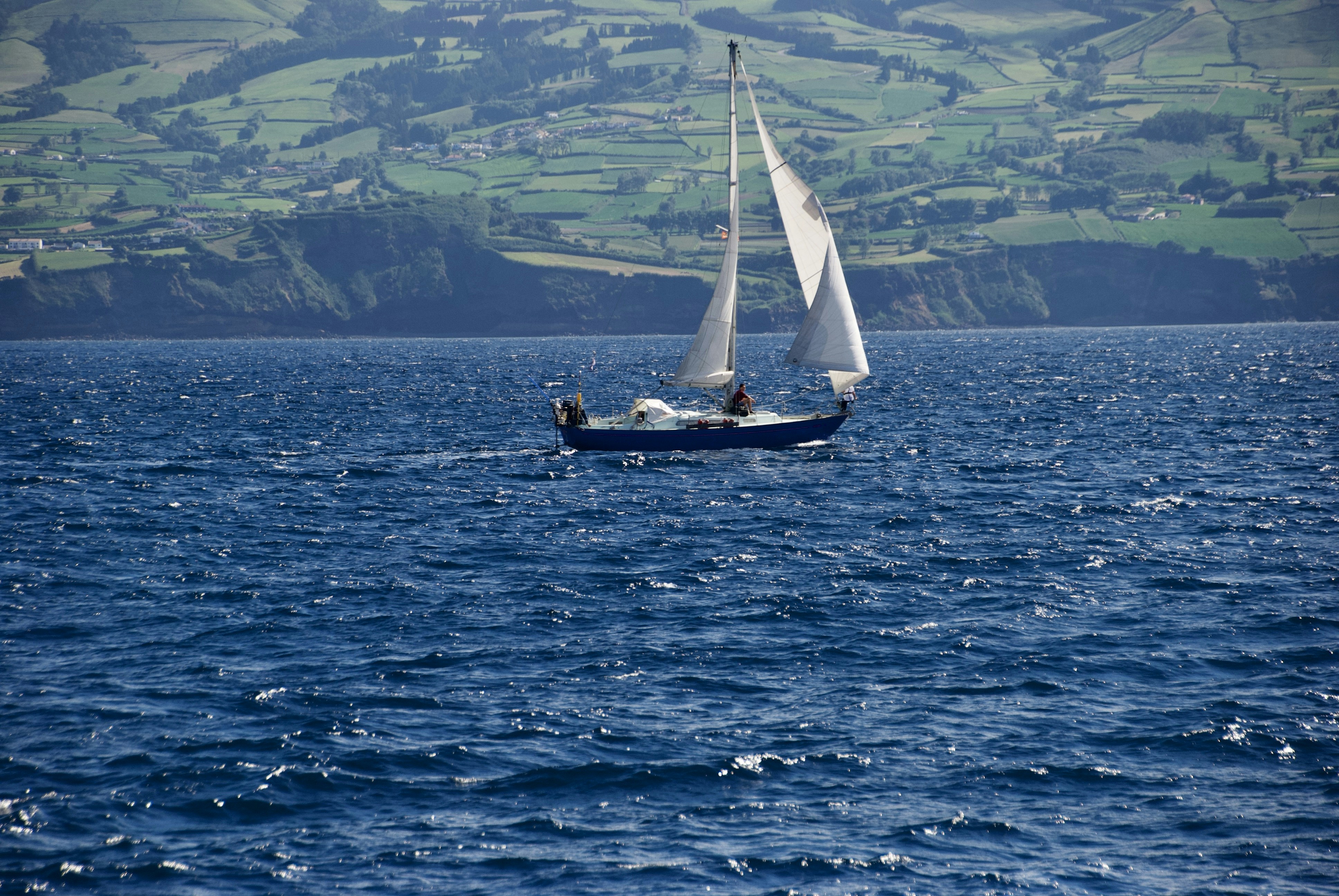 White sailboat on blue sea