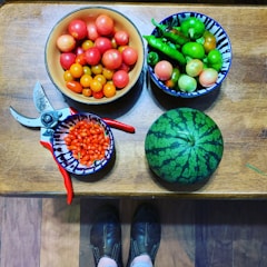 Close-up of hands inspecting fresh products on a wooden table