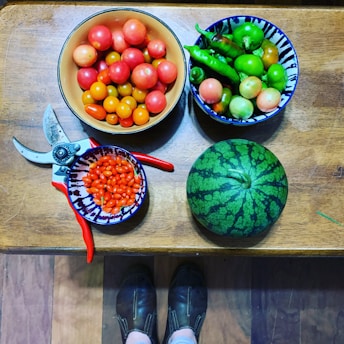 Close-up of hands inspecting fresh products on a wooden table