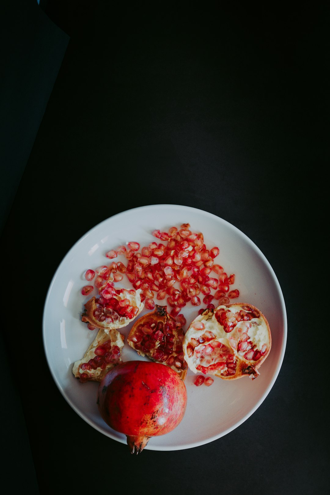 red sliced fruit on white ceramic bowl