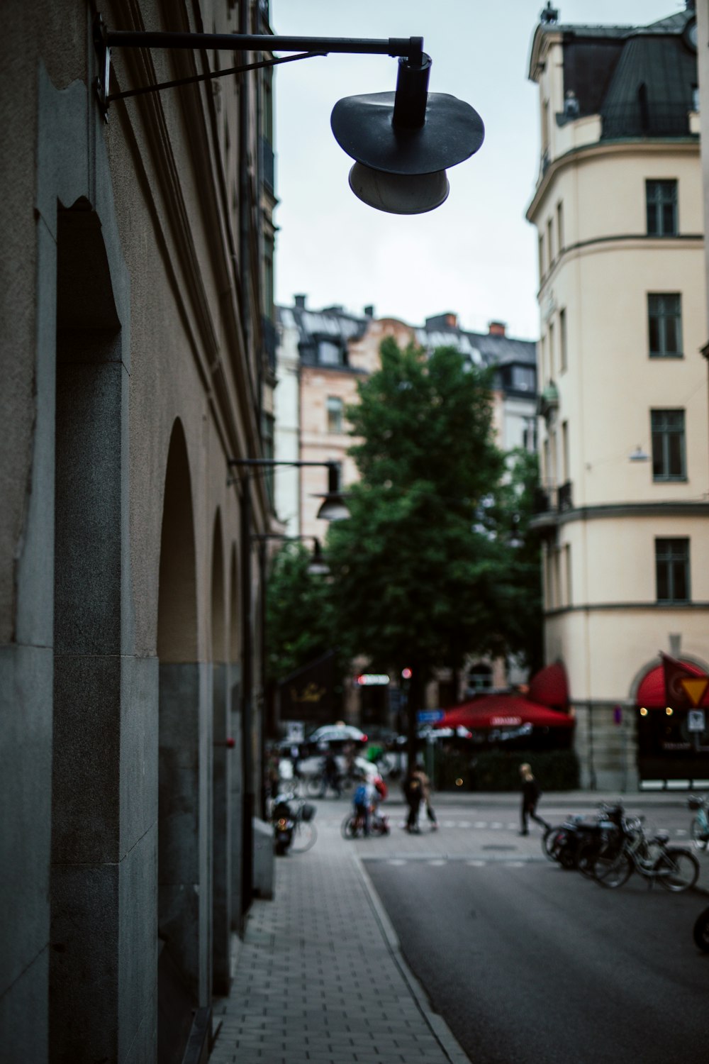 people walking on sidewalk near buildings during daytime