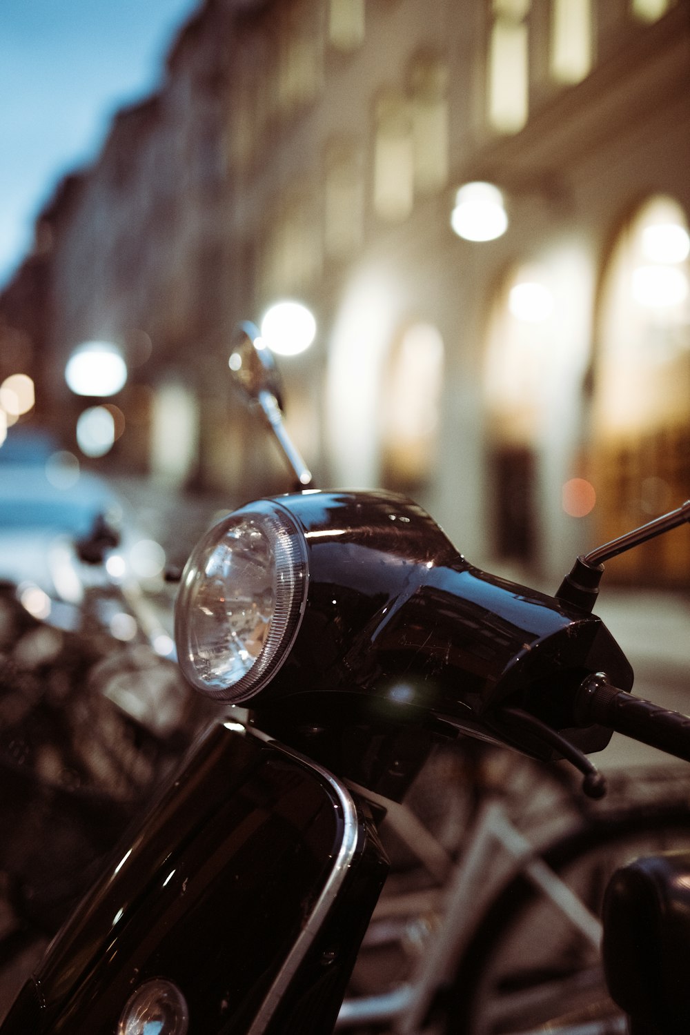 black motorcycle with lights on during night time