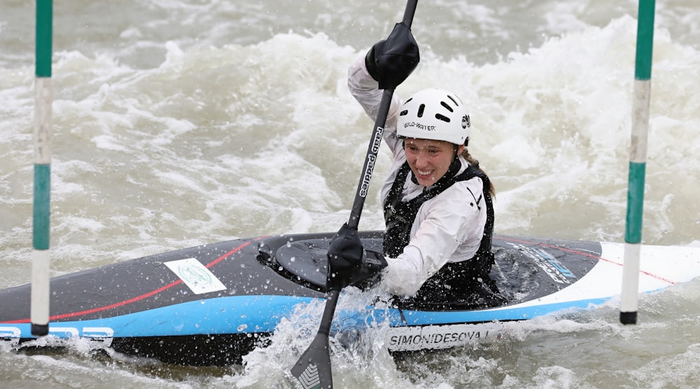 man in black and white helmet riding red and white surfboard