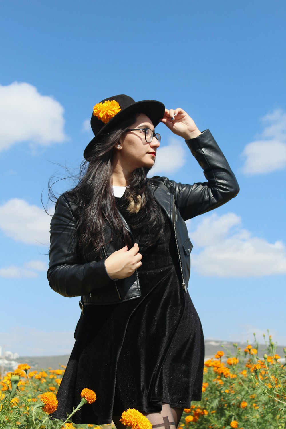 woman in black leather jacket and black hat