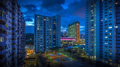 city buildings under blue sky during night time