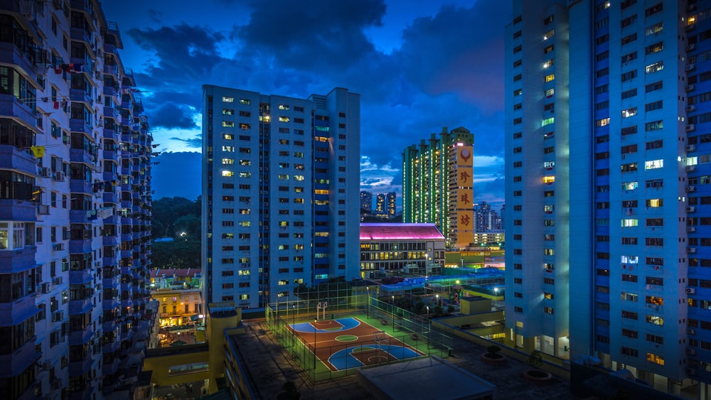 city buildings under blue sky during night time