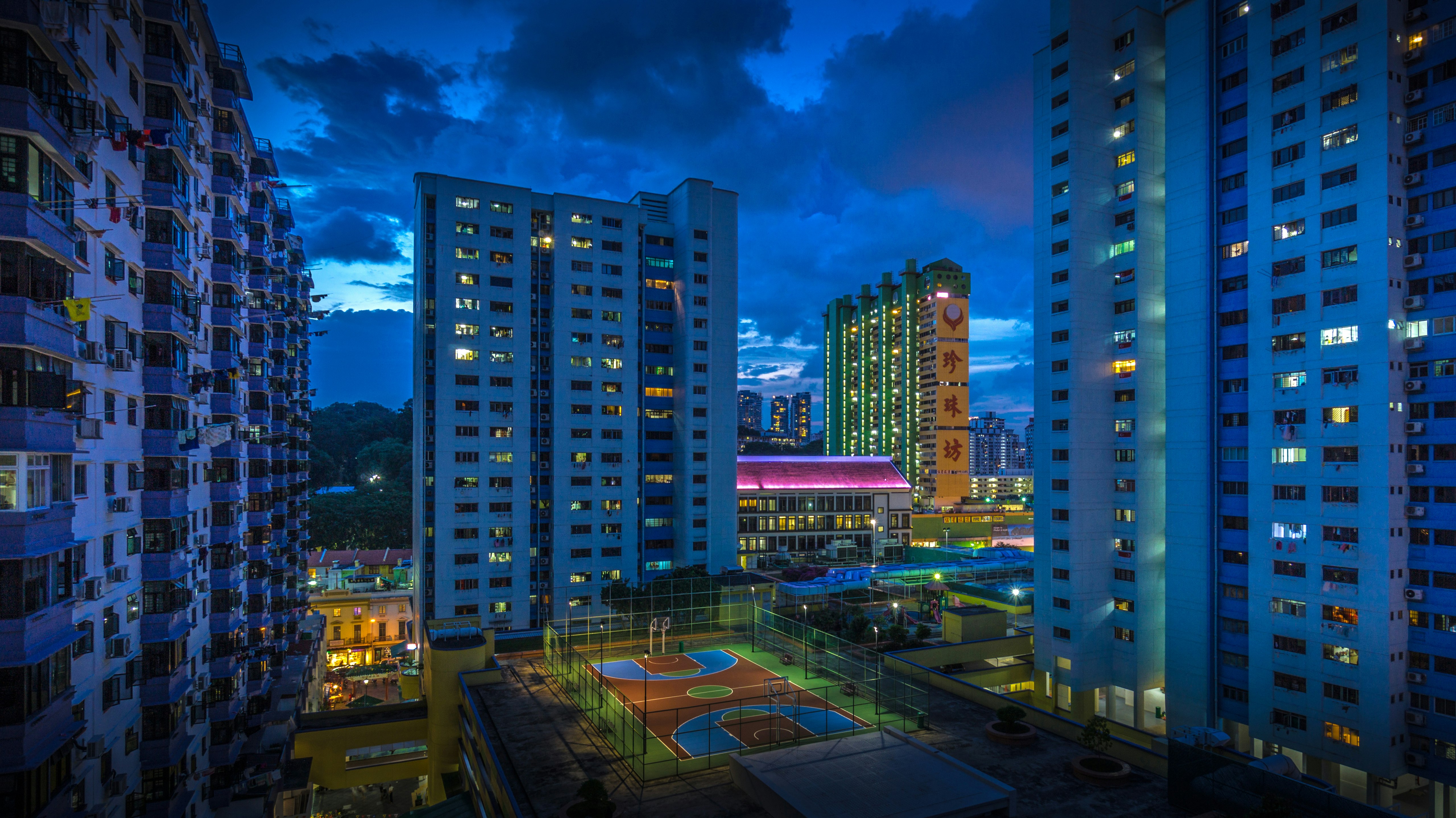 city buildings under blue sky during night time