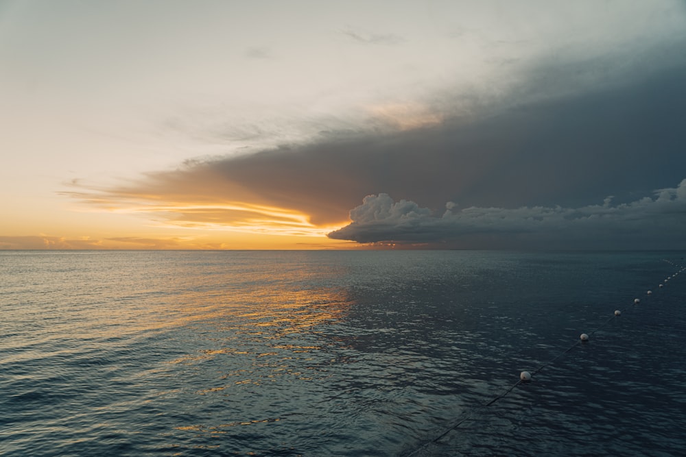 sea under white clouds during sunset