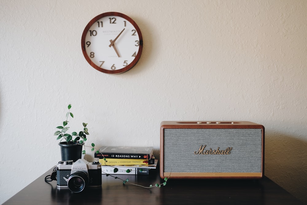 brown and white round analog wall clock at 10 00