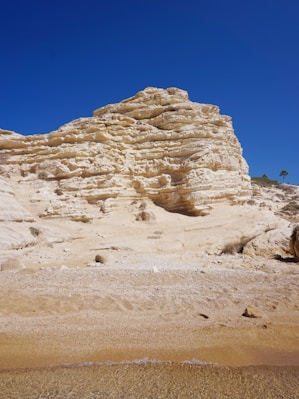 brown rock formation under blue sky during daytime