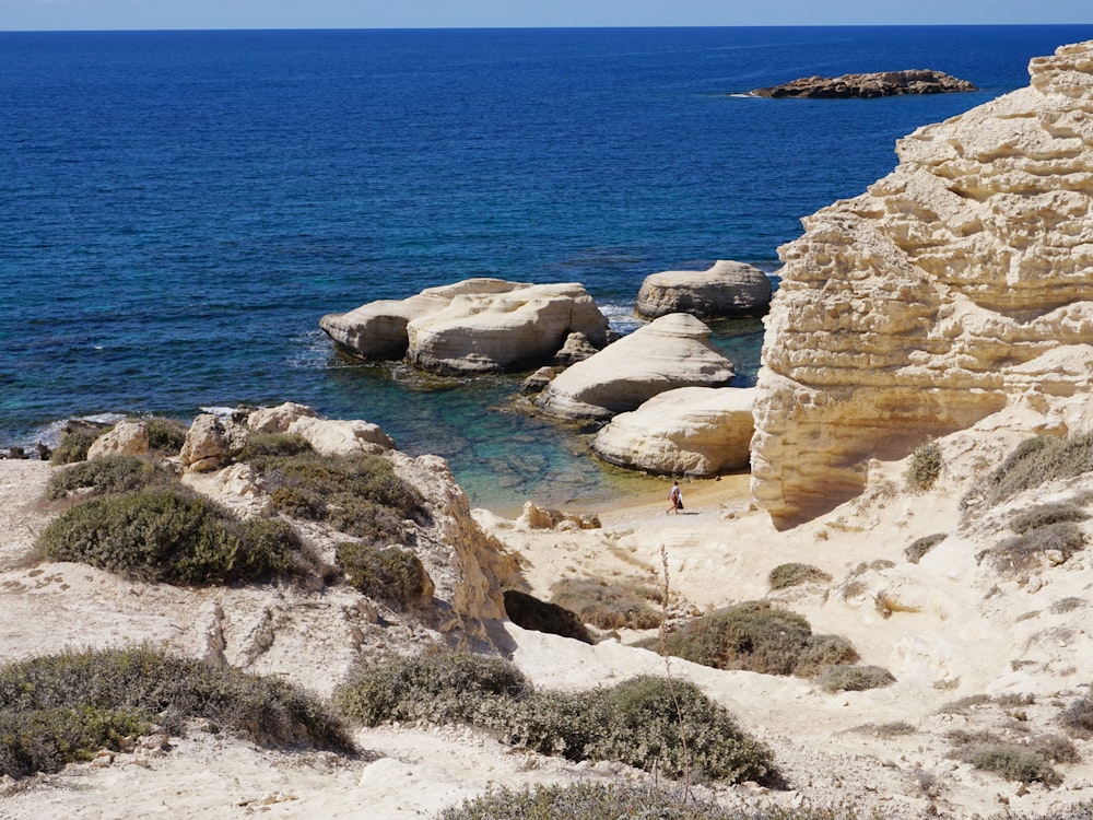 brown rock formation near blue sea during daytime