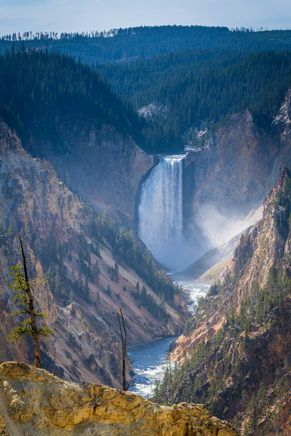 waterfalls in between mountains during daytime