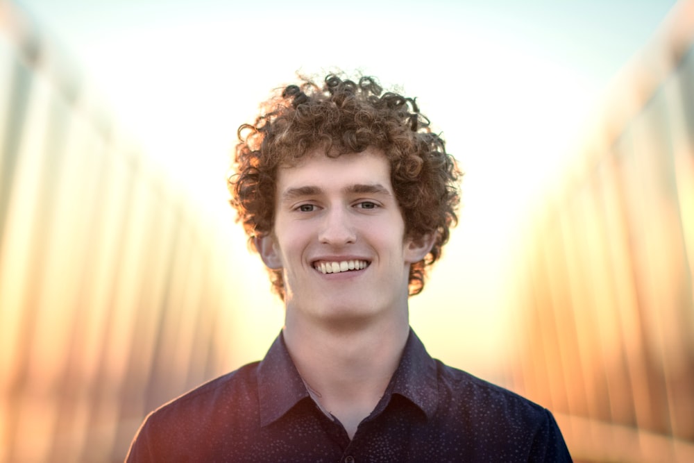 man in black button up shirt smiling